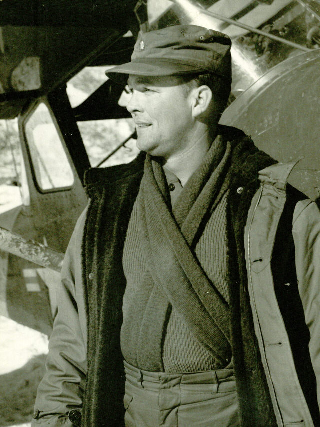 Major Edward L. Barker, USMC, VMO-6, in front of an L-19A observation aircraft.